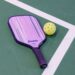 pickleball paddle and ball on court