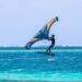 teenager boy surfing on a hydrofoil board in a sea